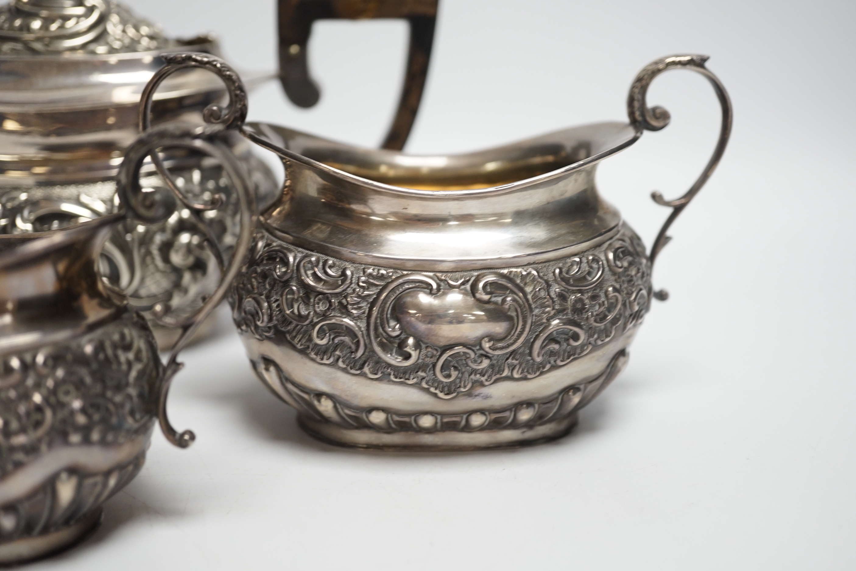 A matched late Victorian silver three piece tea set, maker's Haseler Brothers and John Round & Son Ltd, Birmingham, 1899 and Sheffield, 1900, gross weight 19.3oz.